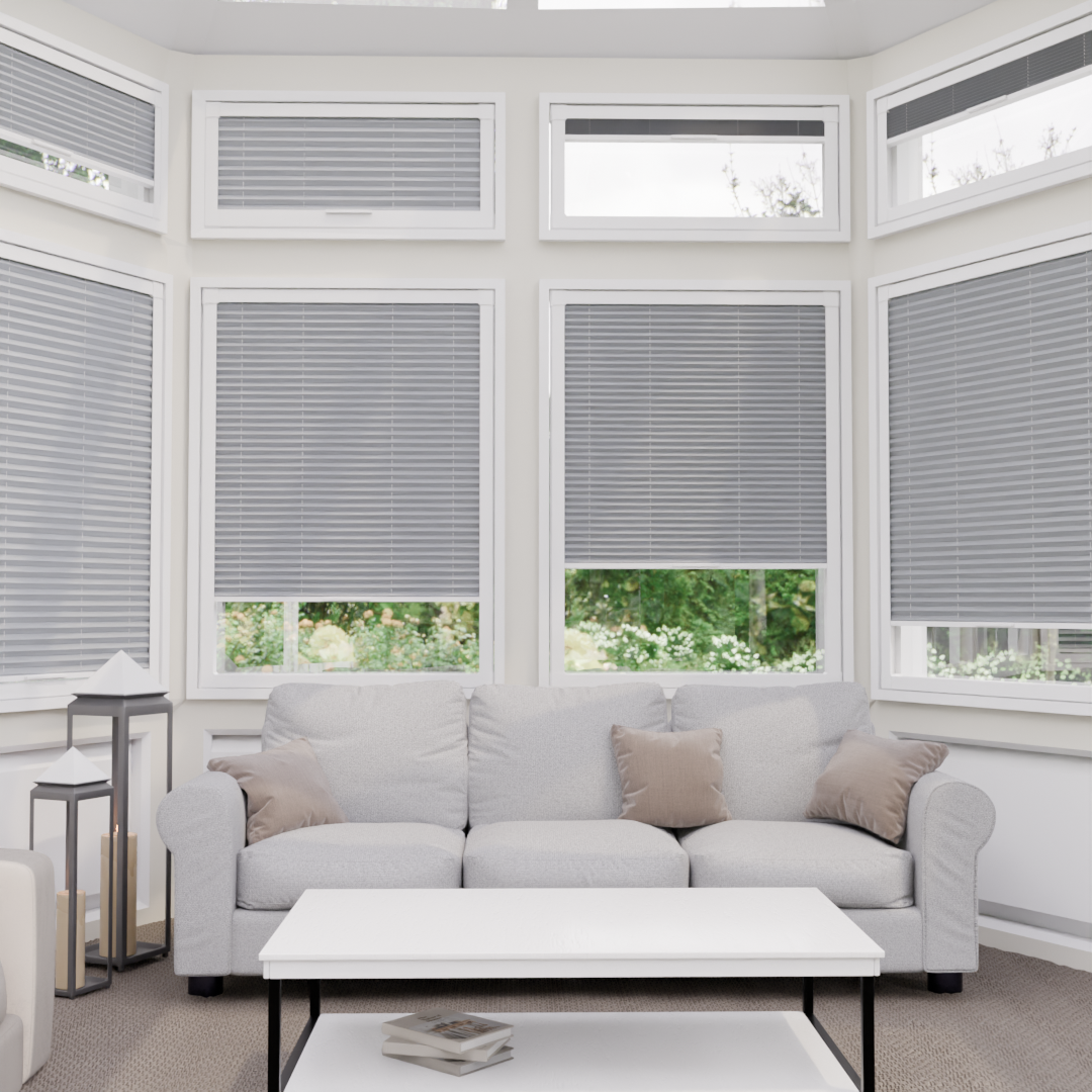Living room with gray window blinds and a white sofa.