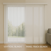 A modern living room with large sliding doors showing a comparison of vertical blinds on one side and panel track blinds on the other, illuminated by soft natural light.