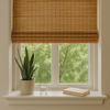 Eco-friendly bamboo blinds in a modern home window with indoor plant and natural daylight, representing sustainable window treatments