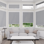 Living room with gray window blinds and a white sofa.